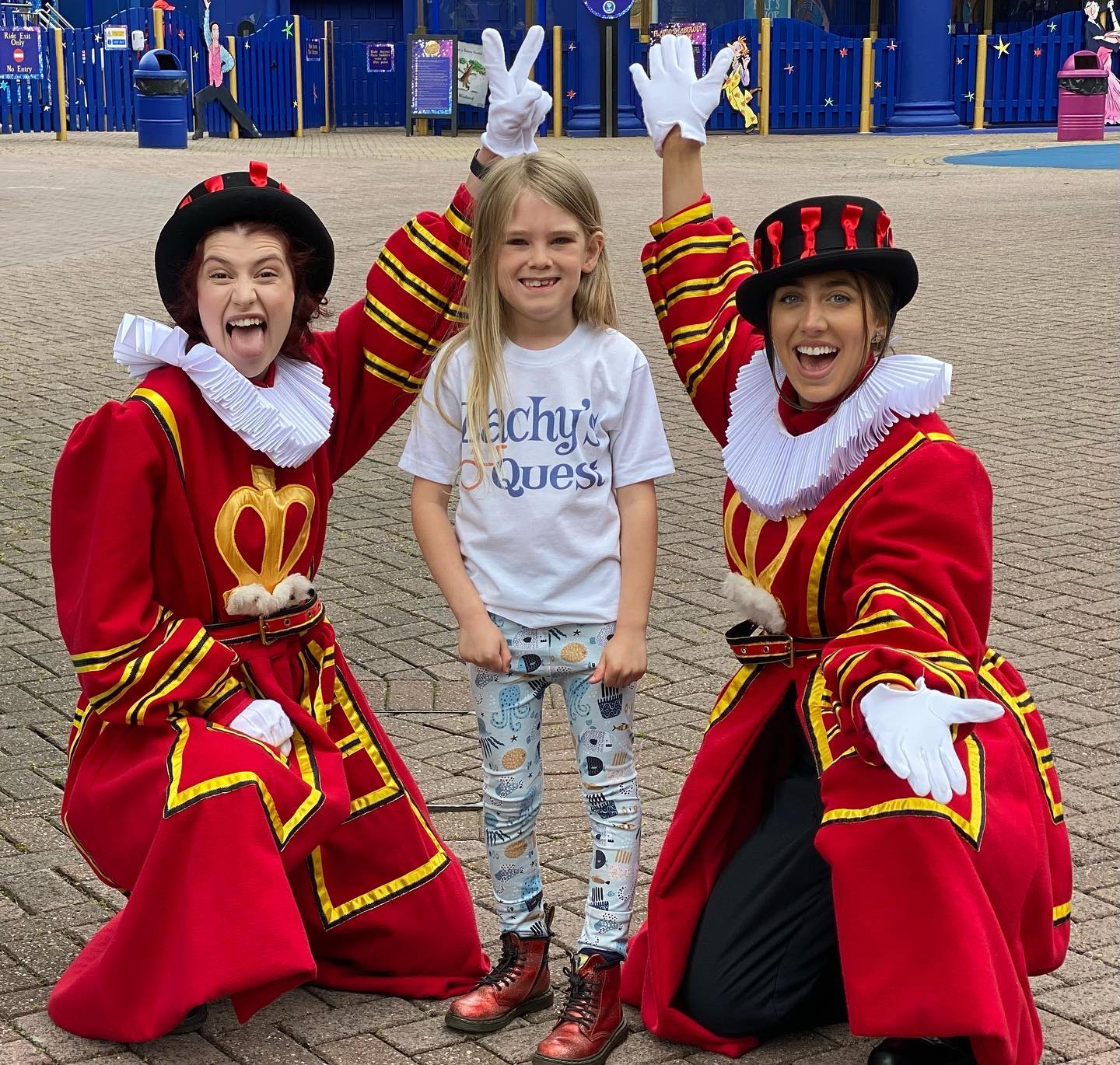 A boy stands with two Beefeaters at Alton Towers Resort 