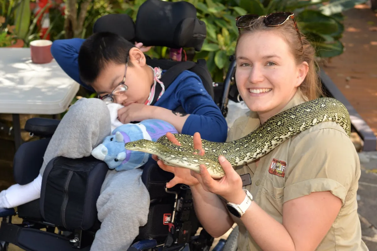 Two people enjoying their magical day out with a snake